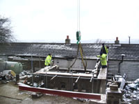 Oak beams for floor lifted into place
